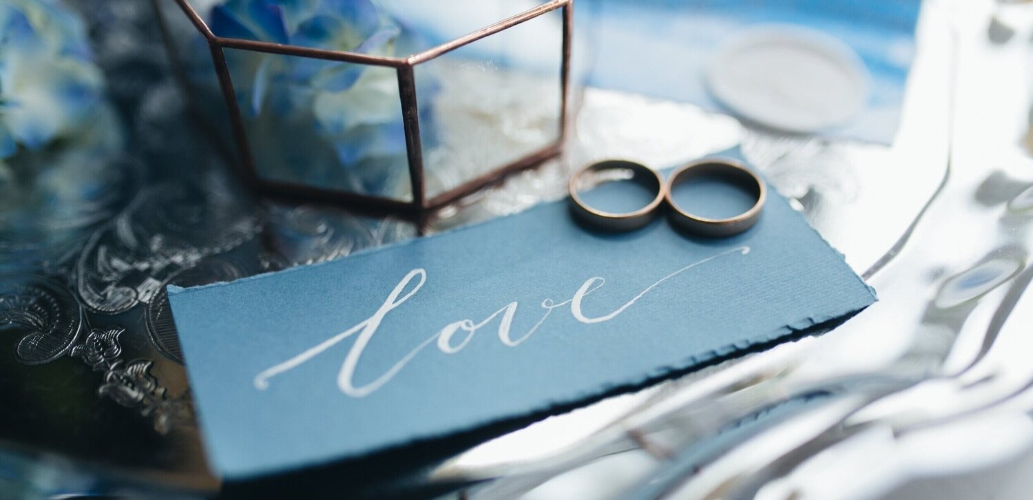 wedding-rings-at-wedding-invitation-with-decoratio-L7UM4YV